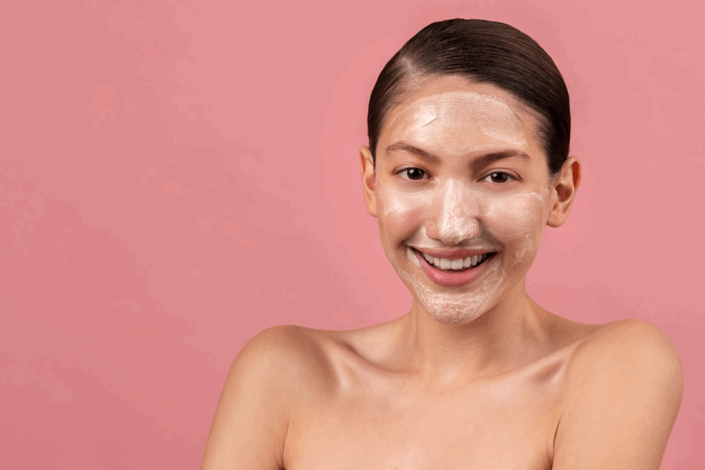 Smiling woman with facial mask as part of aesthetic skincare treatment