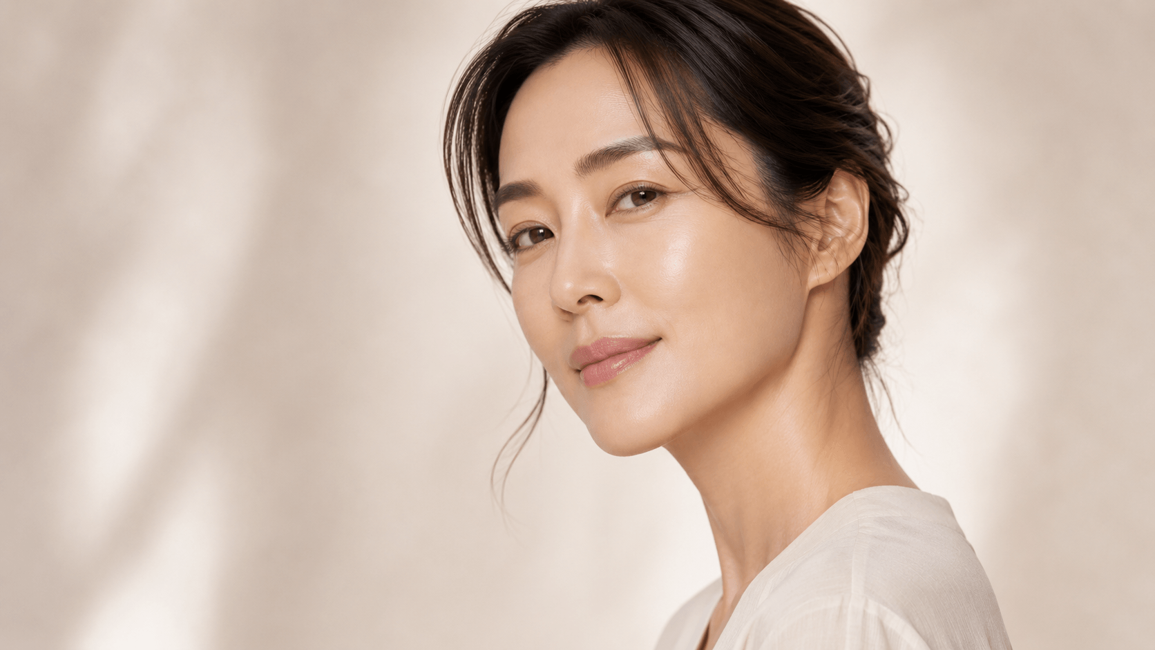 Asian woman in her mid-30s with naturally firm and healthy-looking skin, cheek and midface angle