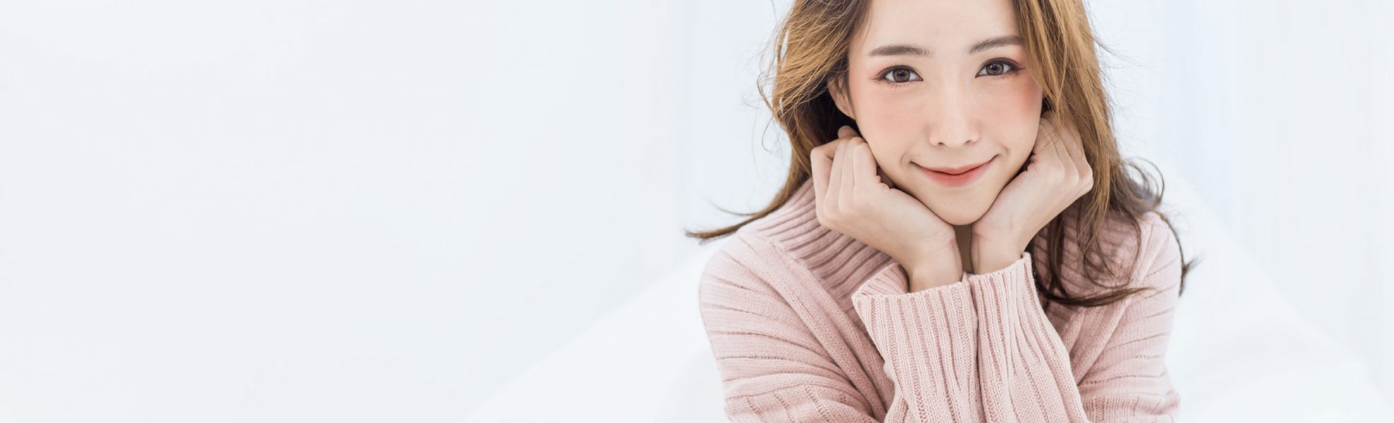 hifu treatment asian women in pink sweater