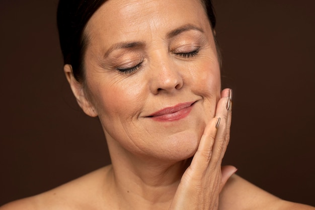 fair skinned adult woman touching her face