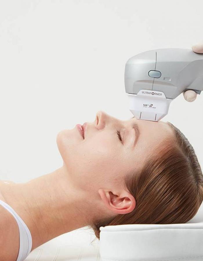 machine on woman's forehead