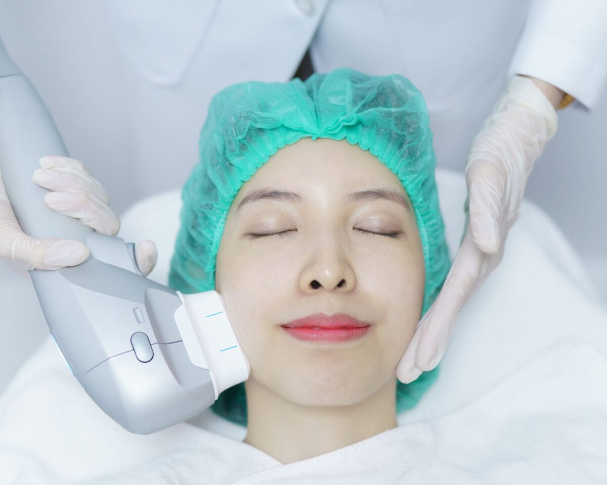 Woman receiving HIFU treatment on face for skin tightening and lifting