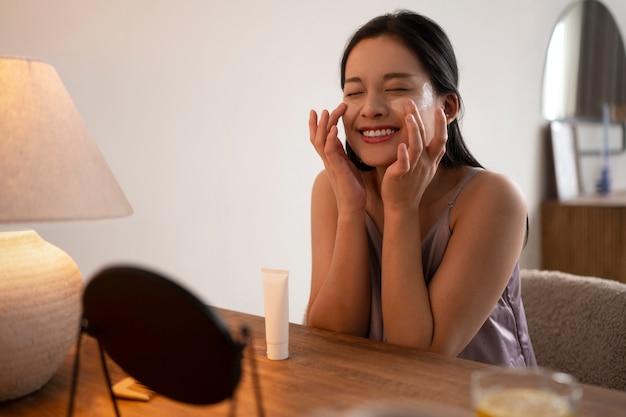 Woman doing nighttime skincare with moisturising face cream